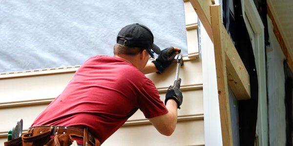 man applying nails on wood